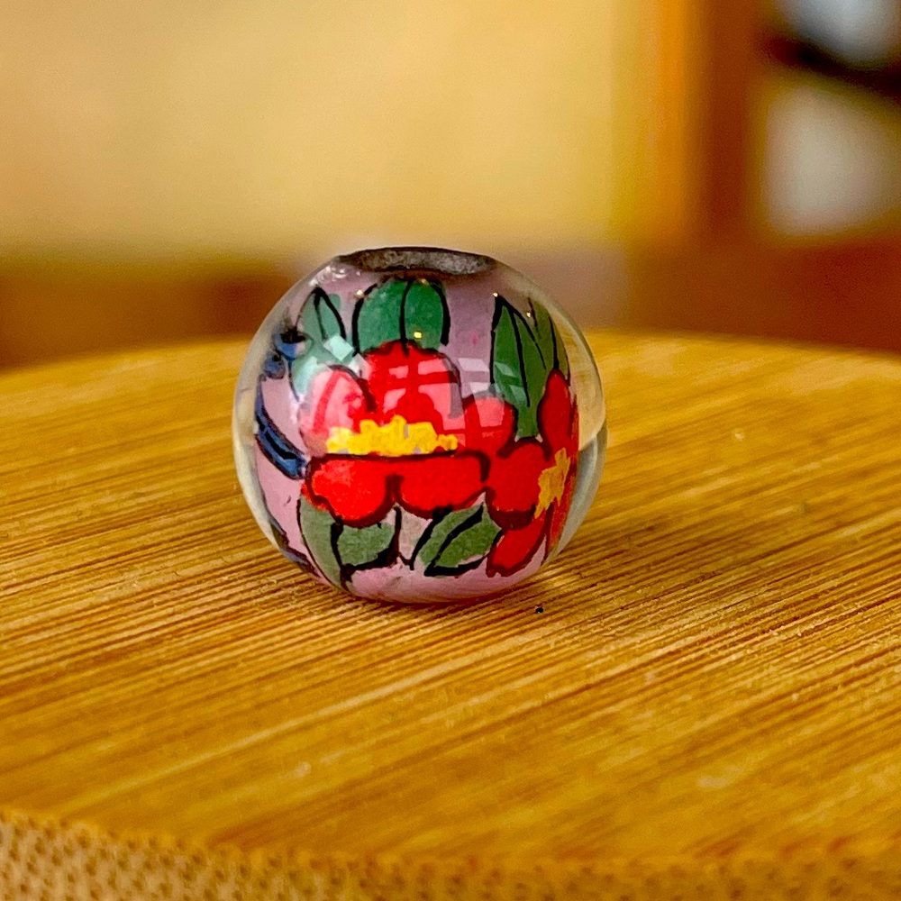 Reverse painted, half inch glass bead with bluebird and red flowers